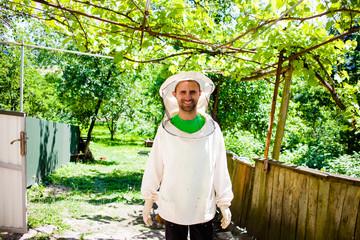 Naklejka na ściany i meble .A man in special clothes for care of bees
