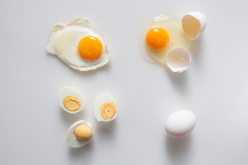 Set of fried boiled raw eggs on a white.