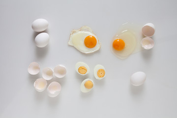 Set of fried boiled raw eggs on a white.