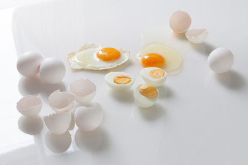 Set of fried boiled raw eggs on a white. Top view