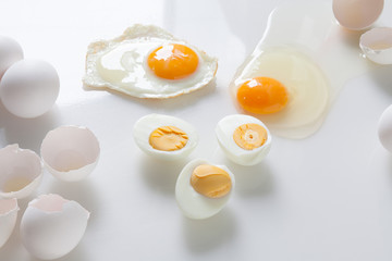 Set of fried boiled raw eggs on a white.