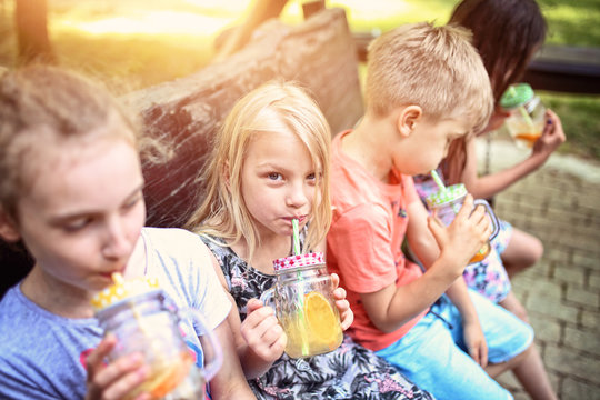 kids drink lemonade on a sunny day