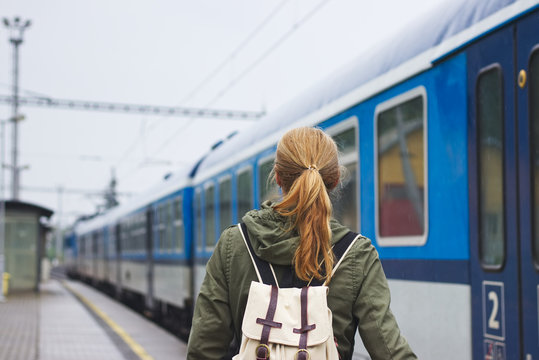 Woman boarding to train at the railway station
