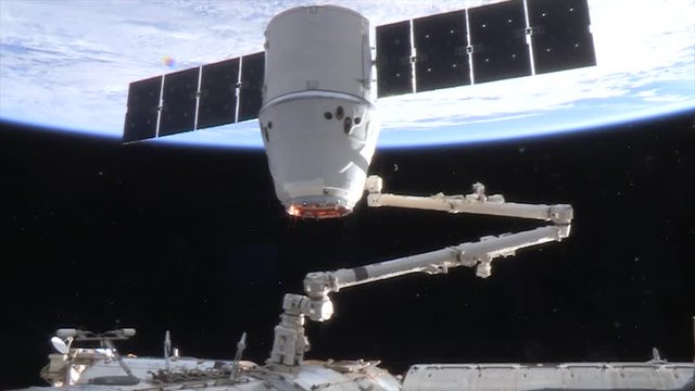 Satellite attached to International Space Station, low angle