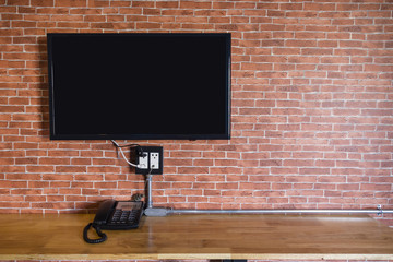 Flat screen television on a brick wall