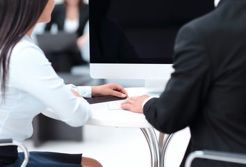 rear view.two successful employee sitting behind a Desk
