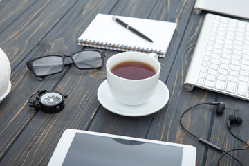 Modern workplace with smartphone and keyboard copy space on wood background. Top view. coffee cup.