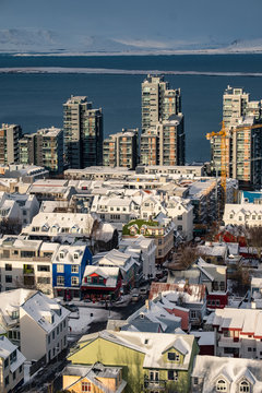 Aerial view of traditional urban developement in Reykjavik, Iceland in winter with snow covered roofs viewed from above.