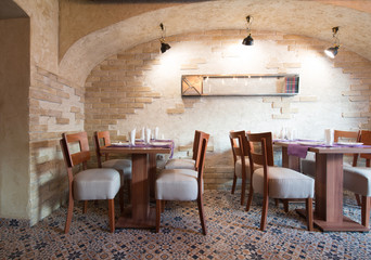 Setting table for four people in restaurant