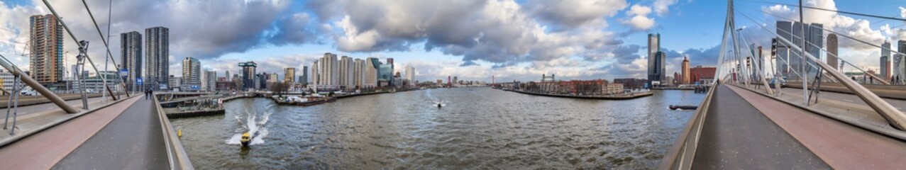 Obraz premium Cityscape, panorama, banner - view from the Erasmus Bridge to the River Maas and the City of Rotterdam, The Netherlands