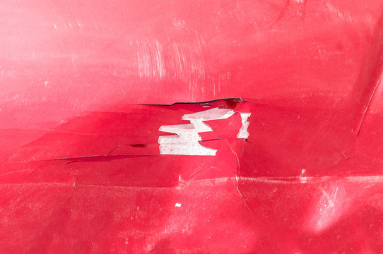 Hood Of The Red Car With Scratched And Damaged Paint Peeled Crack From The Crash Accident Close Up