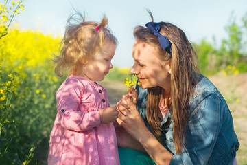 Beautiful, funny, my mother with a little three-year-old daughter is walking in the sunny, warm,...