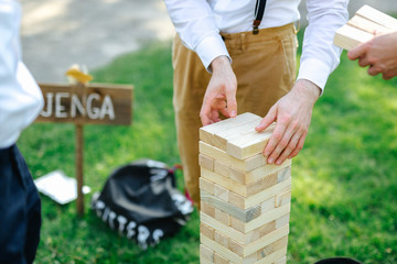 playing jenga outside at a wedding 