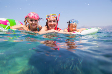 family swimming in the sea