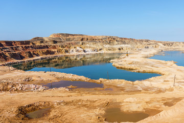 Fototapeta na wymiar Top view of natural blue lakes in a sandy quarry on a Sunny day
