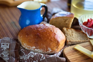 Rural food background with bread,fruit and blue jug.
