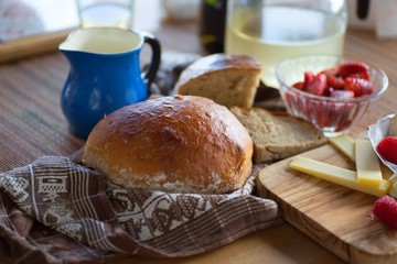 Bread,cheese and red fruit with blue pitcher.