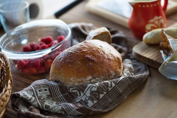 Bread, strawberry, cheese and old red jug on board.