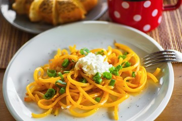 Pumpkin noodle with cottage cheese and onion shoot.