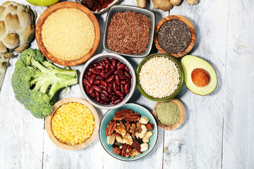 superfood concept on white table with avocado, goji and nuts and seeds.