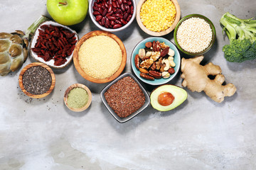 Fototapeta na wymiar superfood concept on stone table with avocado, goji and nuts and seeds.