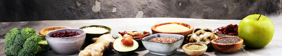 superfood concept on stone table with avocado, goji and nuts and seeds.