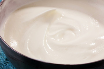 close up of a white whipped or sour cream in bowl.