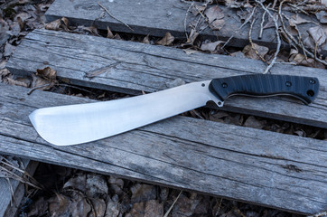 A large knife on a wooden pallet.