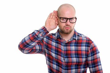 Studio shot of young bald muscular man
