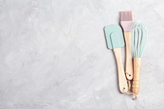 Pastel color kitchen utensils top view.
