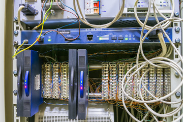 A lot of internet equipment is contained in the switching cabinet. The phone patch panel with...