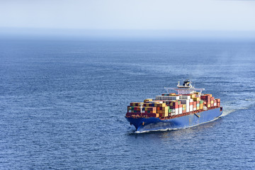 Cargo ship carrying several containers on the waters of the sea of rio de Janeiro, Brazil