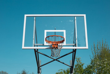 Basketball hoop outdoor on blue sky background - sports