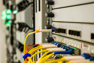 A bundle of optical cables is located in the server datacenter. The main router of the central technical platform of the Internet provider. Multiple optical links