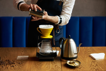 Bartender Hand drip coffee , Barista pouring water on coffee ground with paper filter
