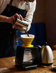 Bartender Hand drip coffee , Barista pouring water on coffee ground with paper filter