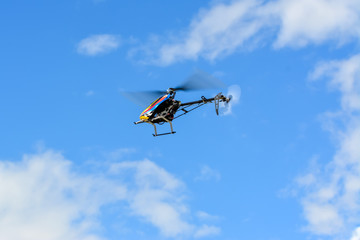 Homemade radio control helicopter on blue sky.