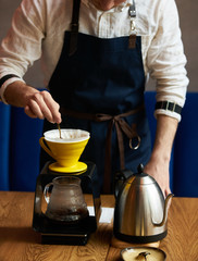 Bartender Hand drip coffee , Barista pouring water on coffee ground with paper filter