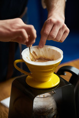 Bartender Hand drip coffee , Barista pouring water on coffee ground with paper filter