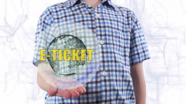 Young man shows a hologram of the planet Earth and text E-ticket. Boy with future technology 3d projection on a modern white digital background