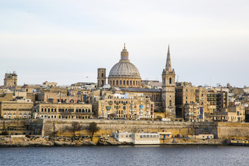 Fototapeta na wymiar Panoramic view of Valleta, Malta at sunrise with Carmelite Church dome and St. Pauls Anglican Cathedral