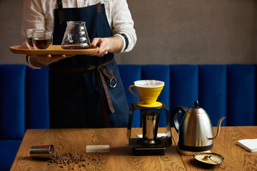 Barista prepare coffee at bar counter using different glassware and utensil, close-up