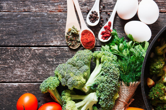fresh broccoli and orange tomatoes, cooked broccoli with mushrooms, carrots and potatoes. organic and vegan food kitchen 