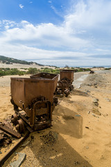 Rusty mine cart on abandoned tracks