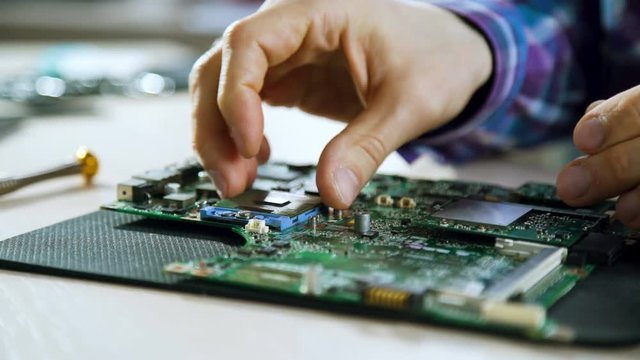 computer upgrade. technology development. microelectronics scientific innovation concept. engineer removing cpu from motherboard socket