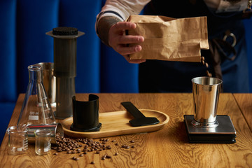 Barista prepare coffee at bar counter using different glassware and utensil, close-up