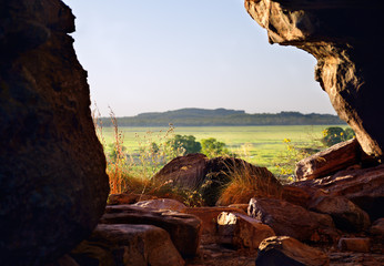 View from inside the rock, looking like window, formation at beautiful sunset in Australian Kakadu park.