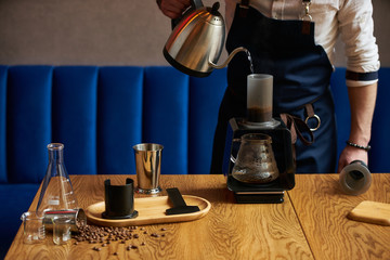 Professional barista preparing coffee alternative method, close-up