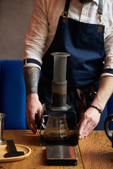 Professional barista preparing coffee alternative method, close-up