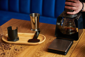 Professional barista preparing coffee alternative method, close-up